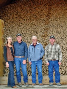 Cottom Seed is a family enterprise operated by Steve and his wife, Cathy; his brother, David; and their father, Bill. Pictured in front of freshly piled Generation III Ranger Russet seed are Cathy, Steve, Bill and David Cottom. Photo by Cottom Seed
