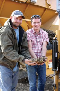 Dan Olteanu and Reagan Grabner with CSS Farms show off some Gala seed potatoes.
