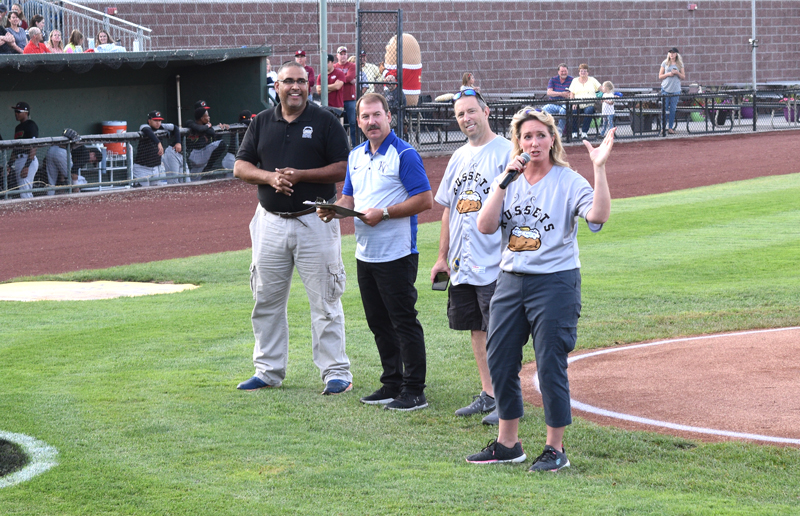 Tater Team member and truck driver Melissa thanks the sell-out crowd for coming out. IPC's Travis Blacker is to her right.