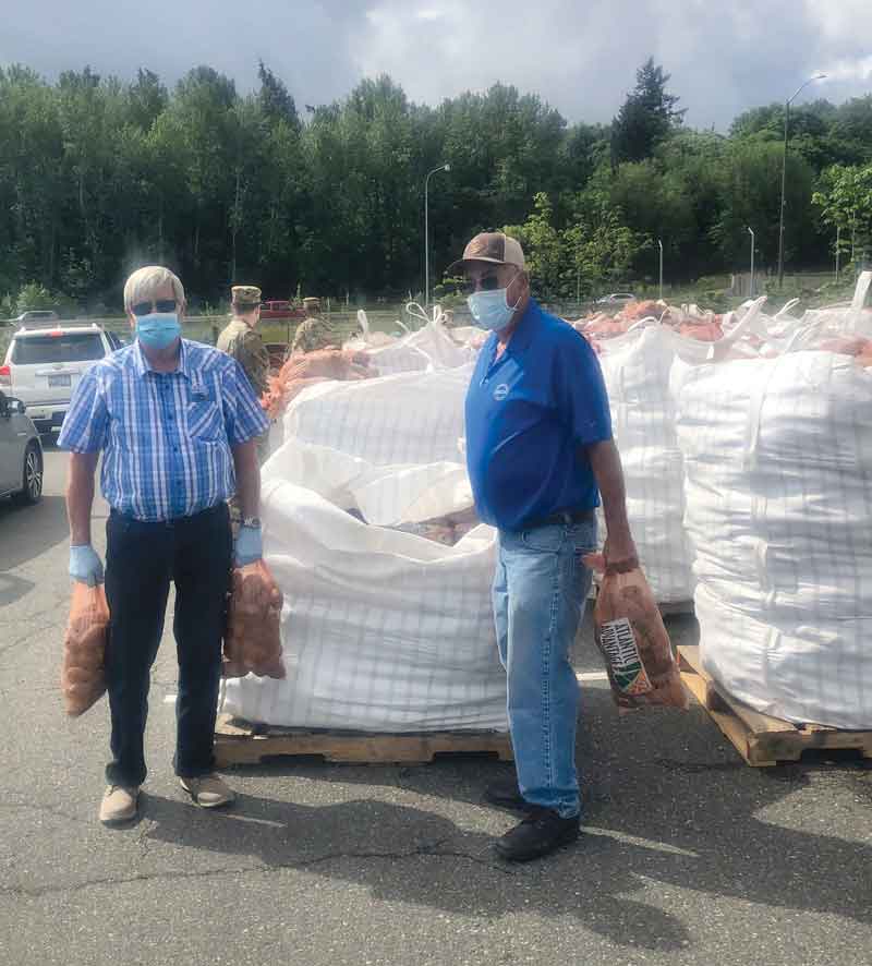 WSPC commissioners Roger Hawley and Ellie Charvet help out at a distribution event in Tacoma, Wash., at which 200,000 pounds of potatoes were donated.